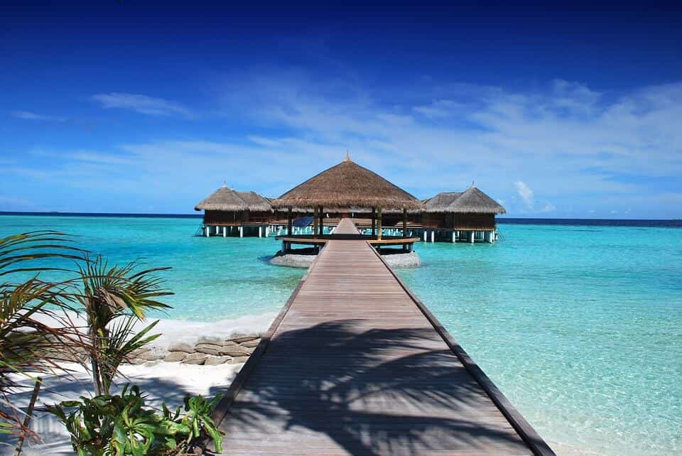 Thatched roofed huts over the ocean in the Maldives