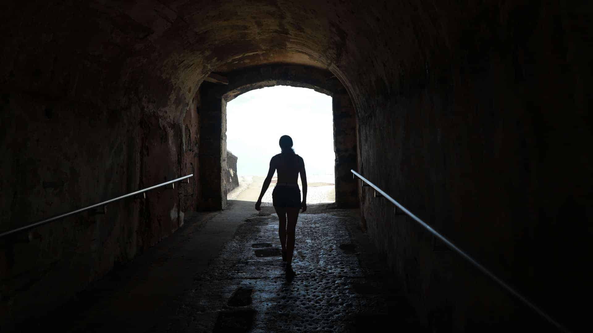 woman emerging from tunnel