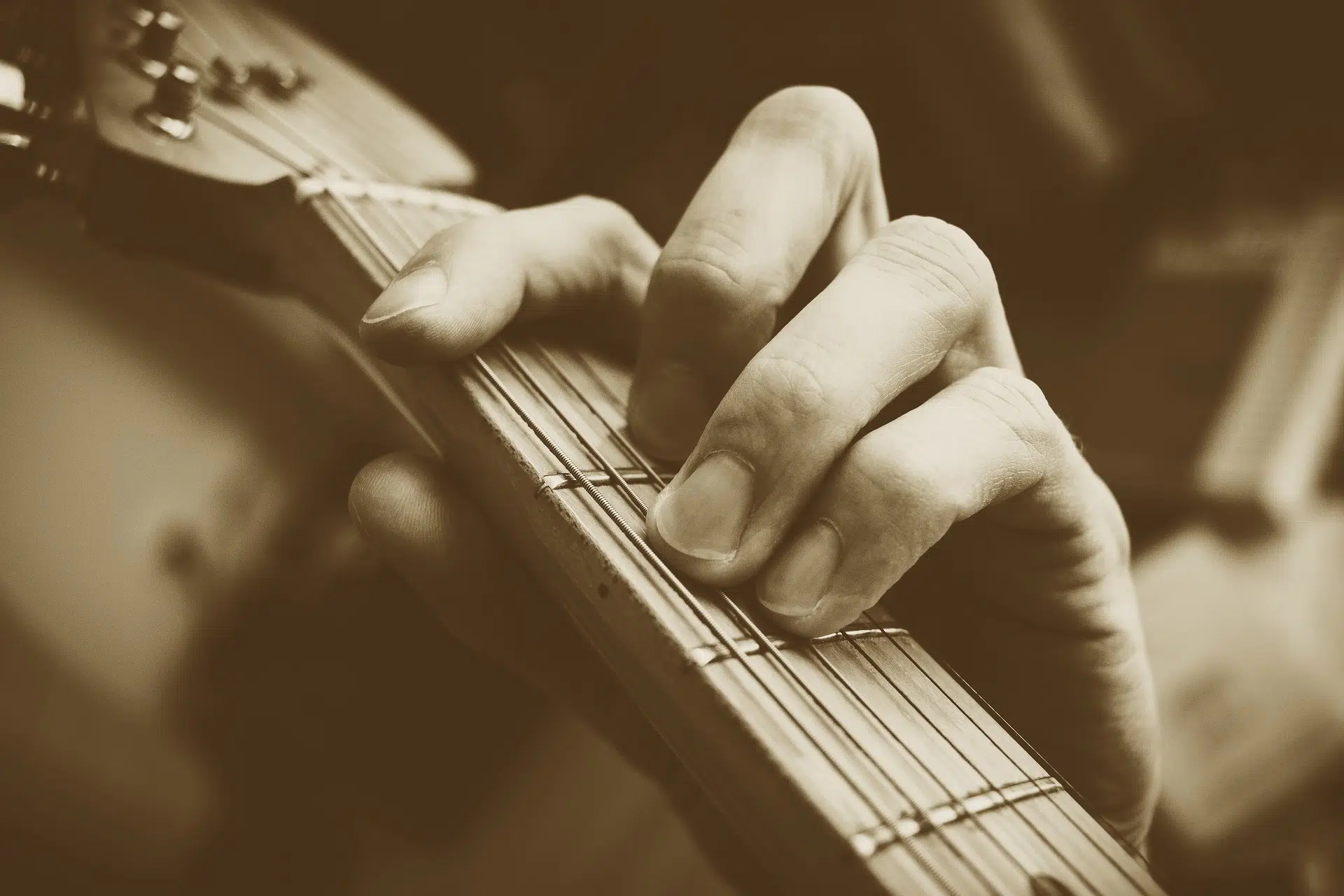 Close up of fingers on guitar fretboard